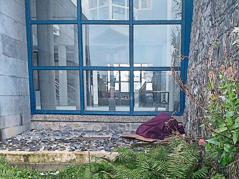 Homeless person sleeping rough outside Limerick City Hall 