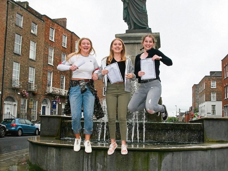 Limerick Tutorial College students Tara Finucane, Sinead McHugh and Lucy Bell jump for joy on results day Picture: Adrian Butler