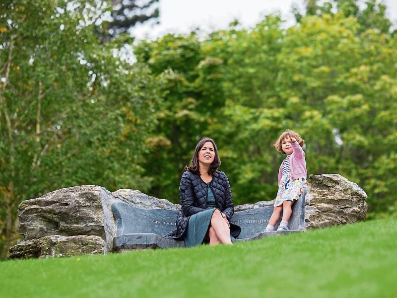 A gentle scholar: Niamh Thornton and two-year-old Sadhbh at the special seat commissioned in Roibeárd’s memory at UL, where a scholarship was also launched this week Pictures: Alan Place