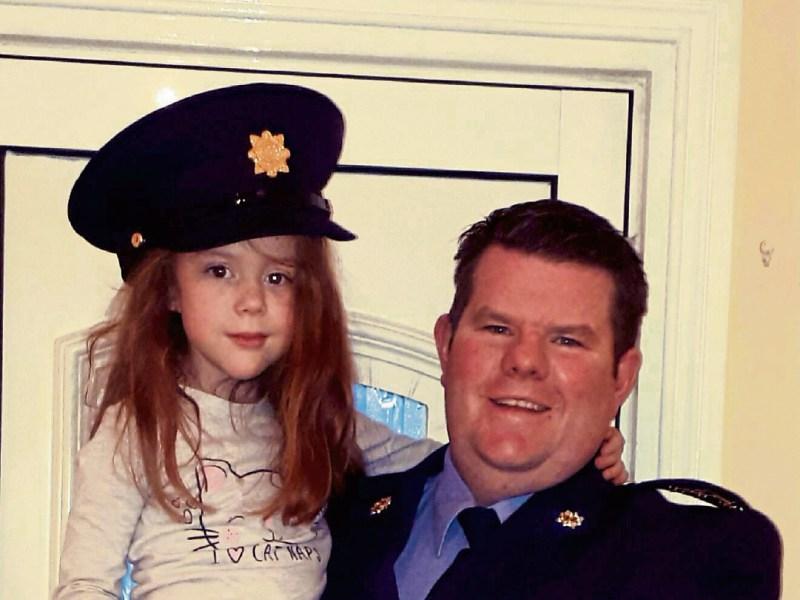 Left: Well done, dad! Garda John Hennessy from Kilmallock pictured with his daughter Aimee, 5