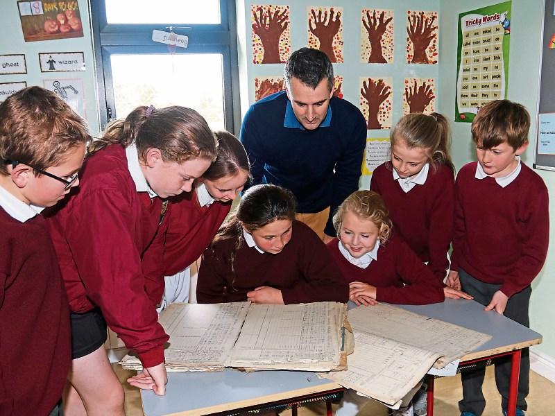 Martinstown National School principal Brian Fitzgerald and pupils pore over roll books