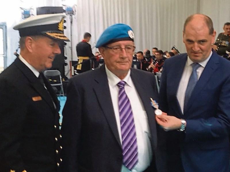 Tadhg Quinn receiving his Bonn Jadotville from Minister of State with responsibility for Defence, Paul Kehoe and Chief of Staff of the Defence Forces, Vice Admiral Mark Mellett