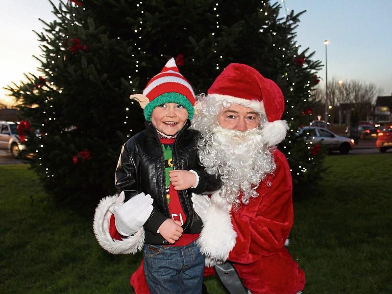 Michael Hennessy, 6, meets Santa at University Hospital Limerick and below, Ryan Heaney with a therapy dog at UHL