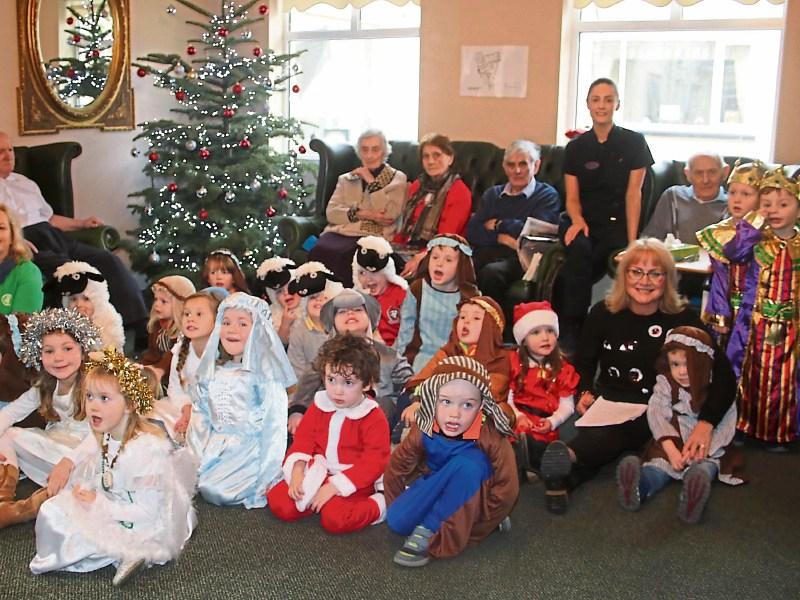 Young and young at heart: Boys and girls from Cute and Clever Playschool, Lisnagry, feel right at home in Rosary Hill House Nursing Home, Castleconnell 