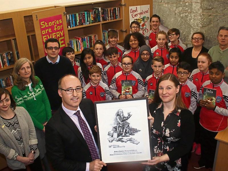 Principal Liam O’Mahony, English teacher Justin O’Connor and members of the students’ council receiving the Robert Dunbar Memorial Library Certificate from Elaina Ryan, Children’s Books Ireland
