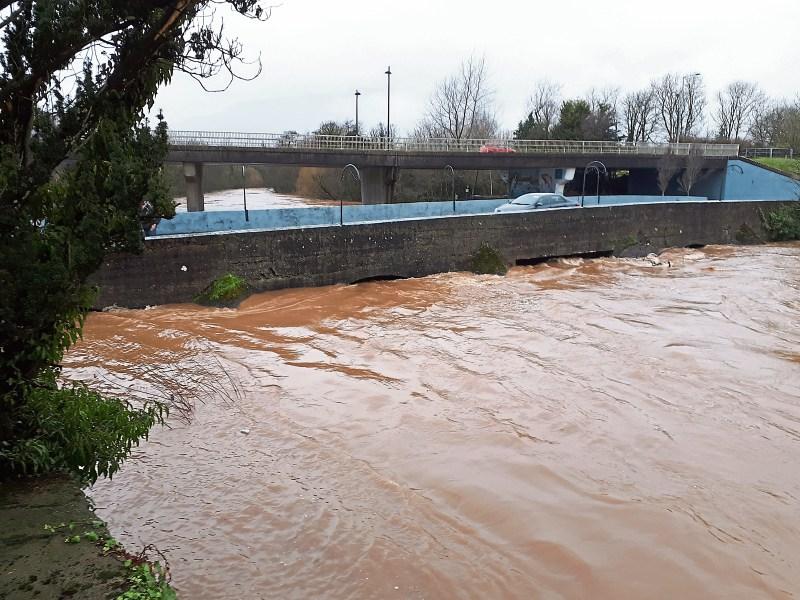 The arches of the old bridge in Annacotty are barely visible due to the volume of water