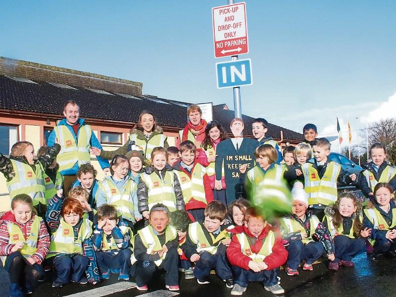 Junior infants from Lisnagry NS and teachers Patrick O&rsquo;Neill, Sheena McDonald, Maura Barry with one of their new road safety signs   Picture: Michael Cowhey