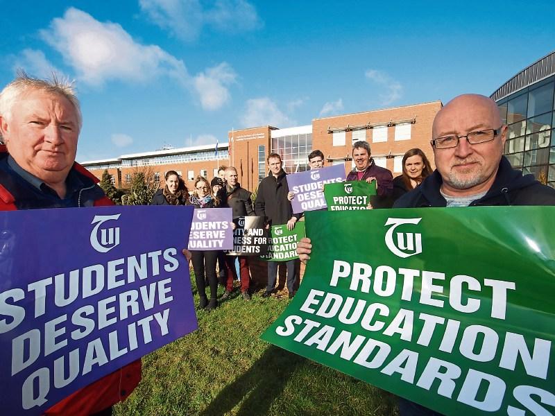 John Costigan and Des Carroll, members of TUI flank fellow lecturers on a lunchtime protest in the Limerick Institute of Technology   