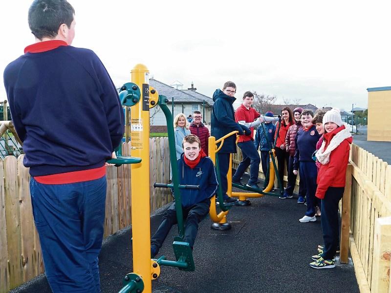 Some of the children enjoying the new equipment at Red Hill school, supplied by AMCS group Picture: Michael Cowhey