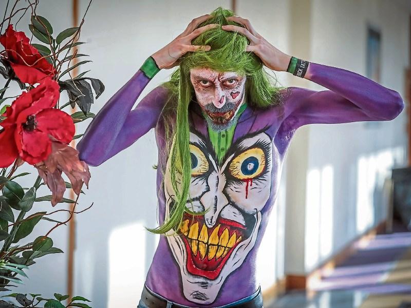 Software Engineer Patrick Hogan shows off his joker-themed body paint which was applied by artist Bianca Schwarza Pictures: Keith Wiseman