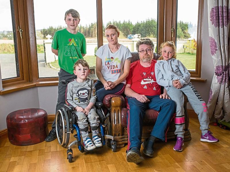Shane Enright 4 with his siblings Aaron and Kaliyah and parents  Richard and Caroline who are at their wits’ end trying to get their Athea home adapted Picture: Marie Keating