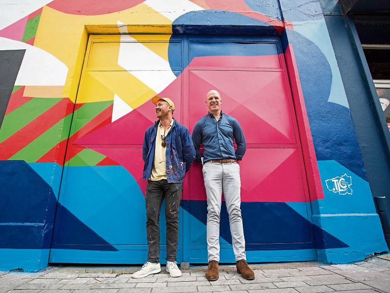 Paul O’Connell representing sponsors TLC with artist Maser, who created the urban art piece unveiled on Thomas Street last week  Picture: Alan Place 