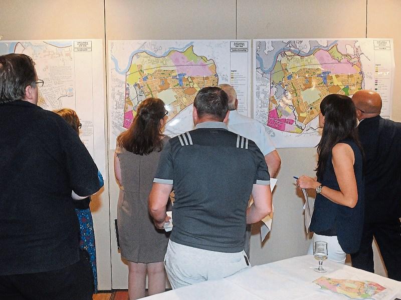 Local residents examining some of the maps which were on display at the meeting