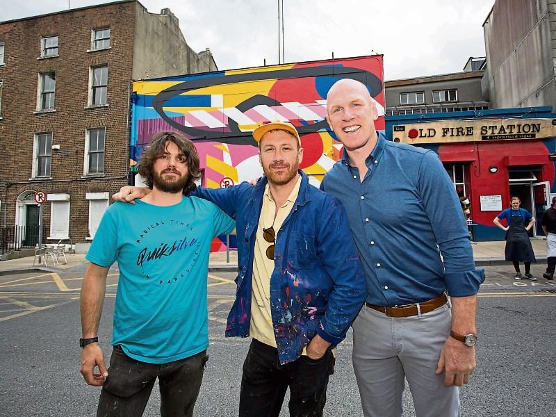 Maser, centre, pictured with Decoy and TLC ambassador Paul O'Connell after finishing a mural in the city recently Picture: Alan Place