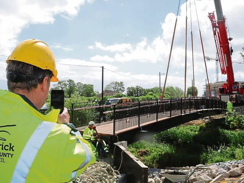 Easy does it! Limerick City and County Council&rsquo;s new &euro;247,000 bridge is carefully lowered into place in Kilmallock Picture: Michael Cowhey
