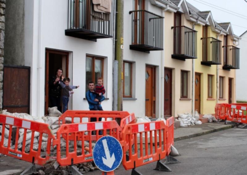 Priscilla and Thomas Harty with their children  Mike and Tommy outside their home on the Quay Askeaton which has been flooded twice in the past month. Picture: Michael Cowhey