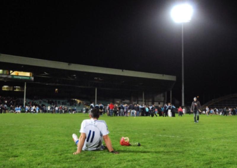 Patrick Lomasney, Feohanagh, dejected after what he thought was defeat to Na Piarsaigh, who celebrate in the background