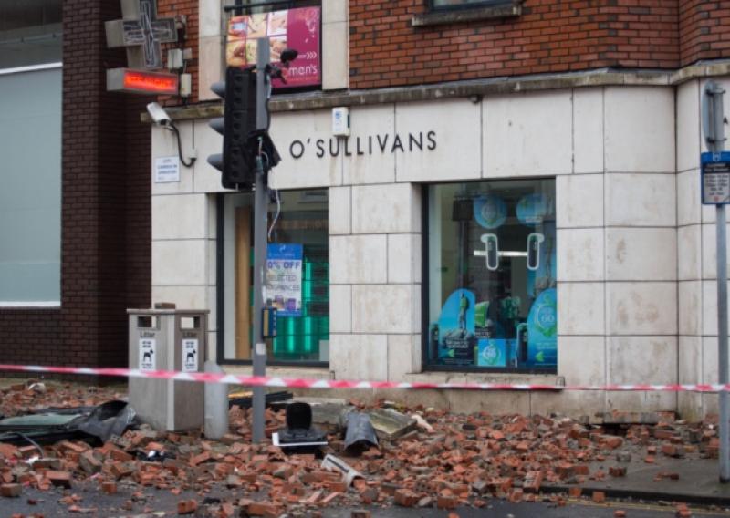 The destruction caused outside Sullivan's pharmacy on Sarsfield Street, after part of the building overhead collapsed. Picture: Alan Place