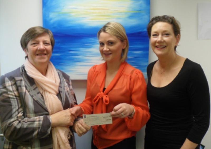 Jessie Griffin, Bruree, hands a cheque to Catheriona Mulcahy and Maeve McSweeney