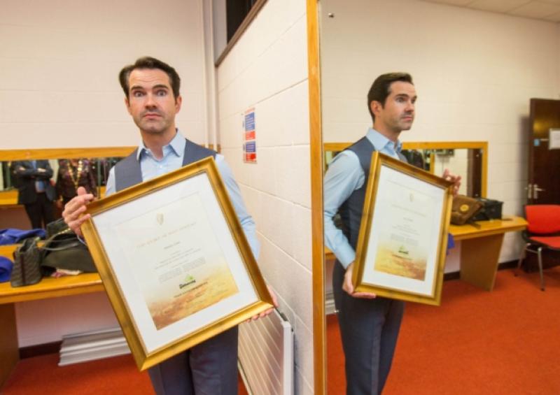 Limerick roots: comedian Jimmy Carr receives a 'certificate of Irish heritage' before his show in the UCH on Saturday night. Picture: Sean Curtin