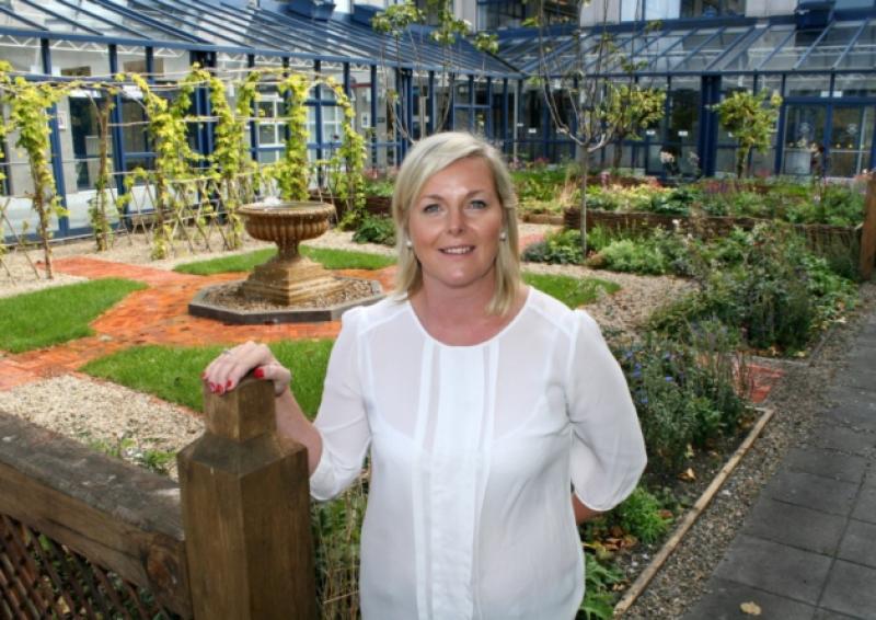 Maria Croke, who works in City Hall, visits the Limerick Culture Garden, created for the recent Bloom festival in Dublin, and now relocated here. Inset, Ailish Drake, who created the garden along with husband Conor Hourigan and which won the silver medal for large gardens at Bloom. Picture: Adrian Butler