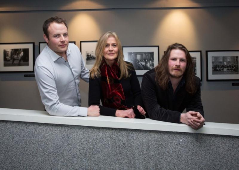 'Completely overwhelmed to see them': Patricia Haselbeck Flynn with her sons Darragh and Sean at the opening of the Glazed Street, the Haselbeck collection of photographs, which has gone on display in City Hall. Picture: Alan Place - below, Ms  Haselbeck Flynn with arts minister Jimmy Deenihan and city archivist Jacqui Hayes. (Picture: Gareth Williams)