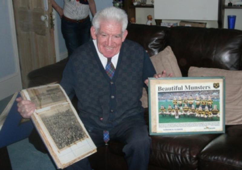 Willie Roberts with two of his most treasured posessions: a cutting of a crowd watching Limericks cup win in 1971, and the Young Munster AIL winning team of 1993.