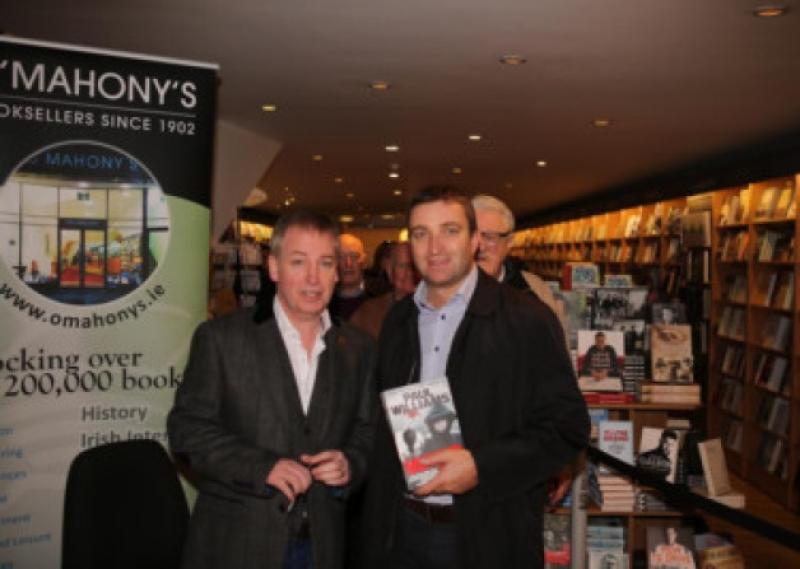 Author and crime journalist Paul Williams with Fianna Fail deputy and justice spokesman Niall Collins at the signing in OMahony's