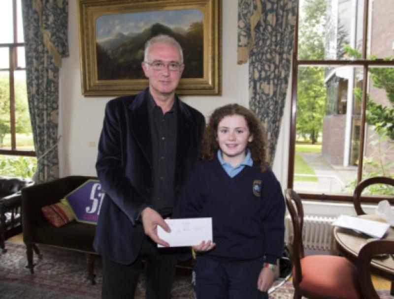 As part of Going For Gold this year a short story competition on the theme 'How would you make Limerick a better place' was initiated. Ciara Murnane, Lough Gur National School, was first prize winner in the primary school competition and is pictured with judge, Joseph OConnor