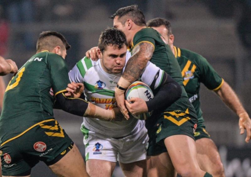 Ireland's Luke Ambler is tackled by James Tamou and Corey Parker, of Australia, during the Rugby League World Cup pool match at Thomond Park on Saturday night