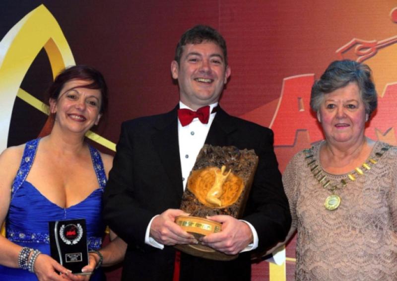 Martin McNelis, Limerick Musical Society,  receives his trophy from Olive Melville, President and Majella Flanagan, Vice-President of AIMS