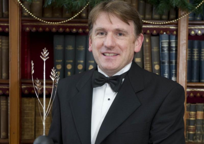 Jim Clarken, chief executive officer of Oxfam Ireland, with his UCC Alumni Achievement Award