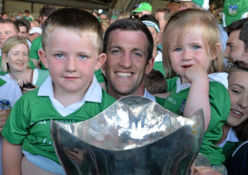 Limerick captain Donal O'Grady holds the cup, along with his children, Danny, aged 3 and a half, and Anna, aged 2, after the Munster final victory over Cork at the Gaelic Grounds