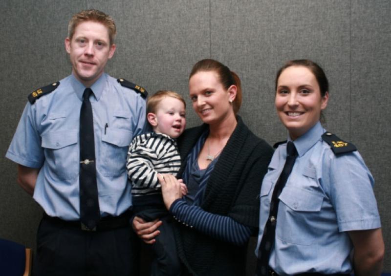 Mum Christine Costelloe, 26, and son Theo, with gardai Orlaith Ryan, and Shaun OHagan, who received the call, and said it was a night they will never forget (Picture: Adrian Butler) and below, my hero: Theo with UL student James Ryan, who found him. Picture: Press 22