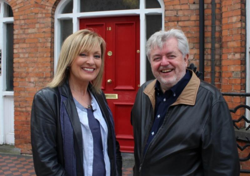 Bill Whelan with RTE Nationwide presenter Mary Kennedy outside his childhood home on Barrington Street. Picture: Mike Cowhey