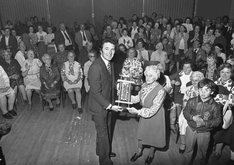 Mike Murphy of RTE presenting the 1978 Ten Knights of Desmond 'glamorous granny' award to 74-year-old Ita Campbell, Newcastle West at the River Room Motel. The event was one of the highlights of a festival that included parades, pageants and unusual competitions