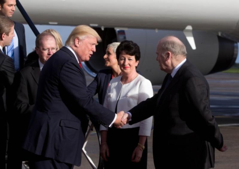 Donald Trump is greeted by Minister for Finance Michael Noonan and Shannon Airport chairman Rose Hynes after disembarking from his personally customised plane at the airport this Monday. Picture: Sean Curtin