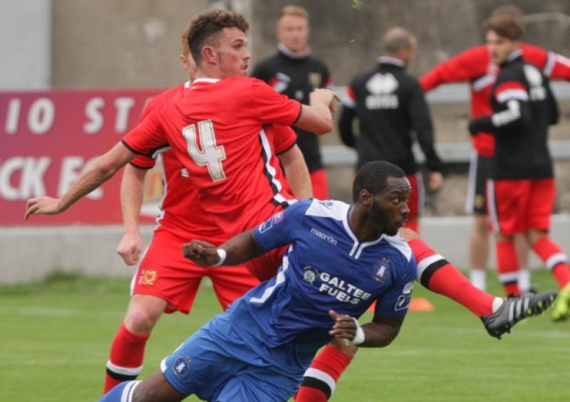 Limerick FC's Patrick Kanyuka battles for possession with Tom Flannigan, of MK Dons, in the clubs' friendly fixture at Markets Field this week