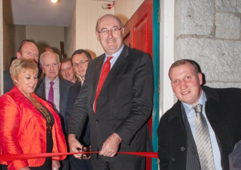 Minister Phil Hogan cuts the tape at the opening of the Red Door Business Incubation Centre, Newcastle West, alongside Ann Liston (left) and local Fine Gael politicans, including Cllr Liam Galvin (right). Picture: Marie Keating