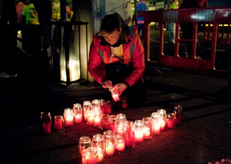 Spelling it out: a  woman lights candles in the shape of the word Hope at last year's Pieta House Darkness into Light walk. Picture: Kieran Clancy