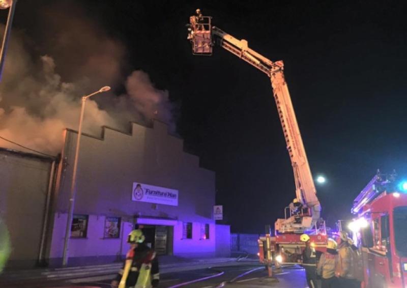 Firefighters tackling the blaze at the Furiniture Man store in Dromkeen