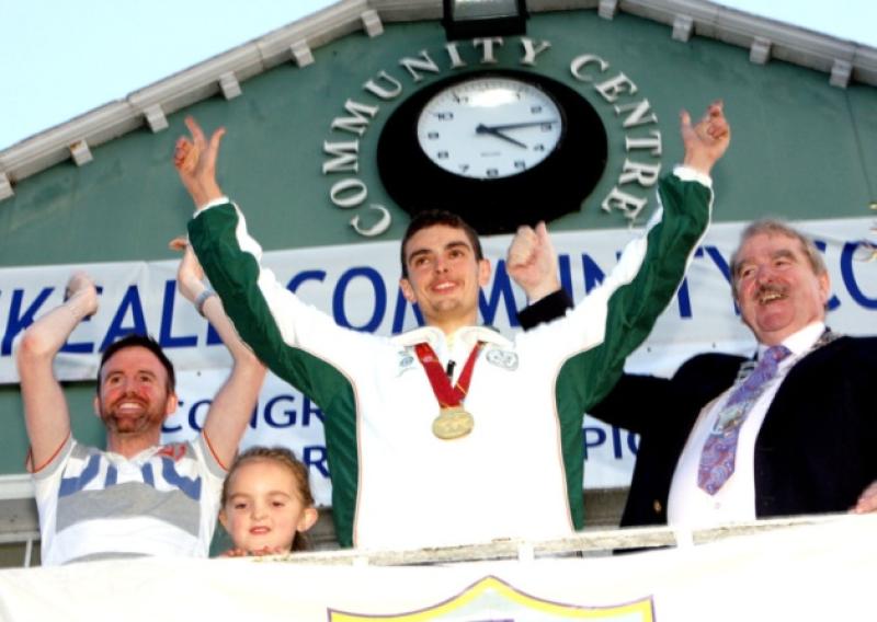 Ian OSullivan, the Junior Men's Trap world champion celebrating in front of a huge crowd gathered at the Square, Rathkeale to welcome him home from the competition in Spain. Also in the picture is Cllr Tom Neville, Cllr Kevin Sheahan, cathaoirleach of Limerick City and County Council, and Amy OSullivan, Rathkeale. Picture: Dave Gaynor