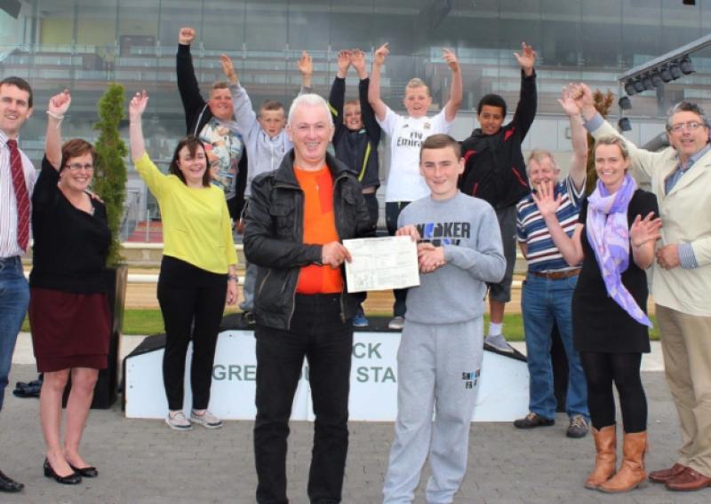 Trainer Chris Houlihan, Cashen Kennels, presenting ownership certificate of new greyhound pup Cashen Spirit to Alan Baily and other youths of Ballynanty Garda Youth Diversion
