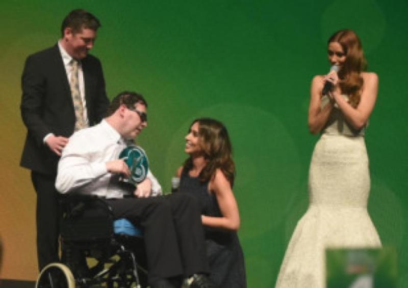 Limerickman Brian Hogan is presented with his award by BBC presenter Christine Bleakley, as Una Foden of the band The Saturdays looks on. Picture: Michael Chester