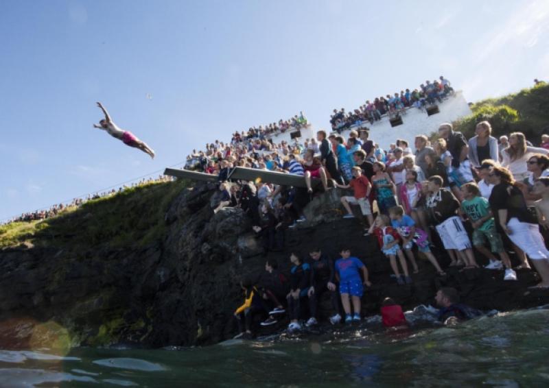 Crowds gather at 'Newfy' for the diving competition in 2013 in this stunning picture by photographer Alan Place. Clare County Council has said that the boards, which were to be replaced this summer, will not be erected for safety reasons. Below, one of the signs erected in recent days in Kilkee by the Council
