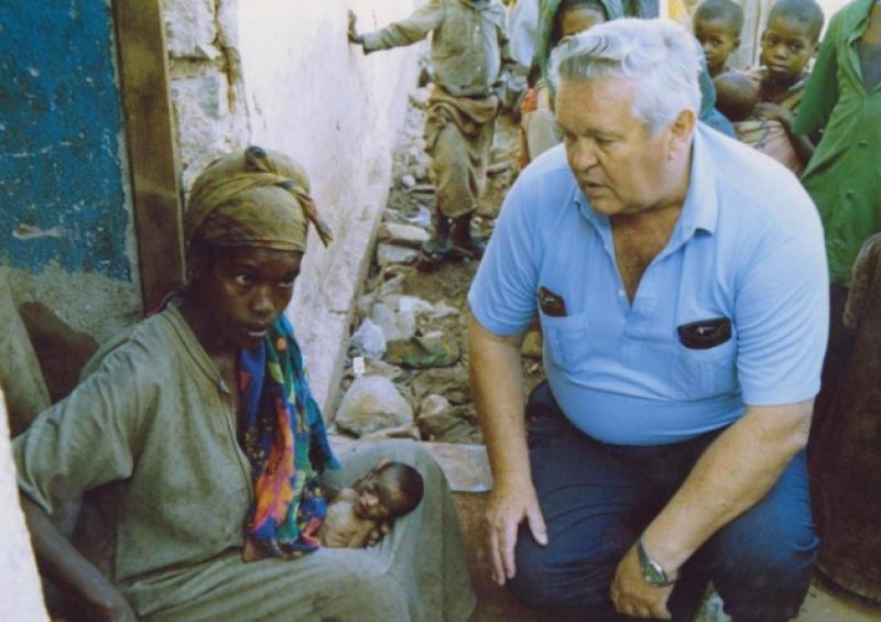 Fr Aengus, who was chief executive of Concern, with a woman and her child in Somalia in 1993. An Irish aid worker was also killed there that year. Below, Aengus with Bob Geldof in Ethiopia, 1985