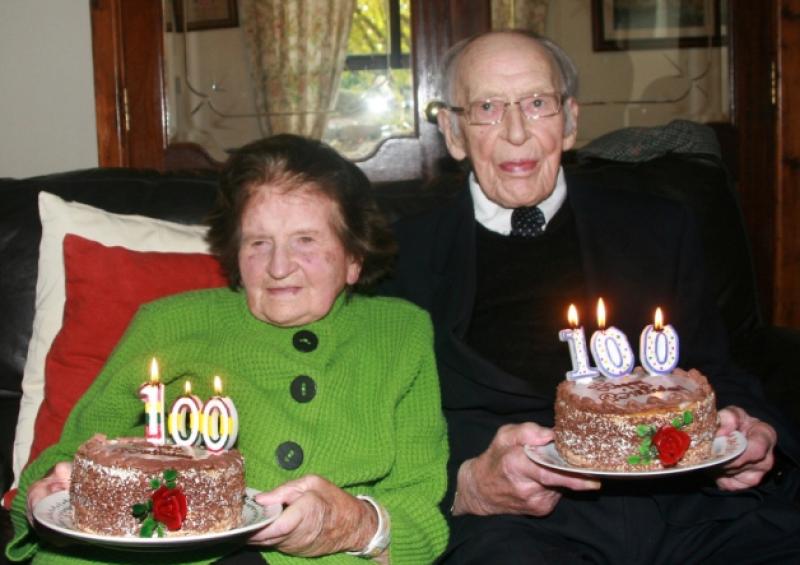 Happy 100 birthday: Bridget Allen and John Lenihan blow out their candles. Picture: Adrian Butler