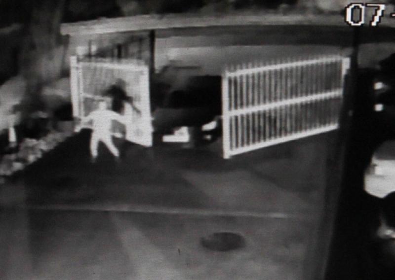 Security footage of three thieves ramming a Volkswagen Passat through the garage's iron gates, before stealing an Audi RS4
