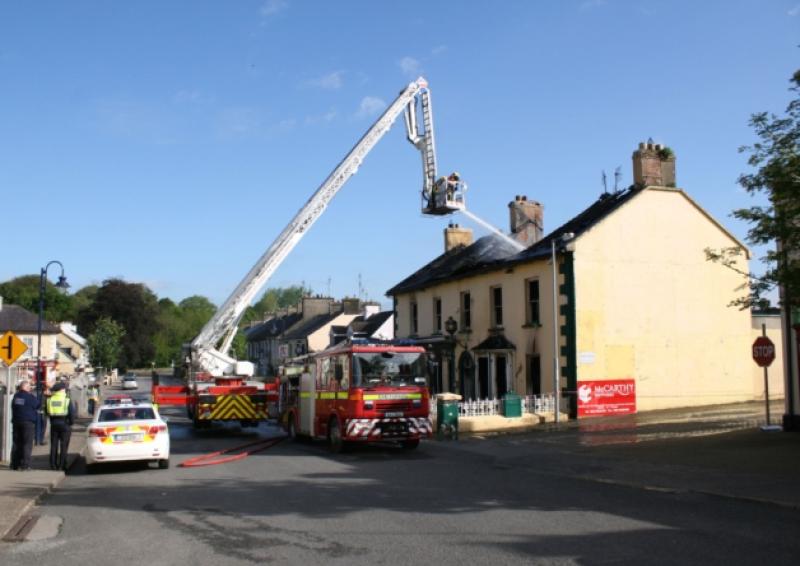 Heads for heights: Fire crews from Limerick city and Cappamore battled the fire in Worrall's Inn on Castleconnells Main Street for hours. Picture: Press 22