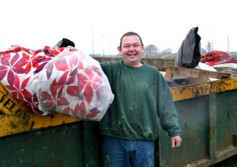 Eamon Murphy dumps some rubbish during the Carew-Kincora skip day [Picture: Adrian Butler]